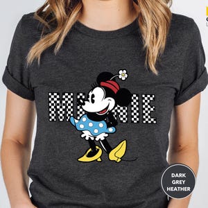 a woman wearing a mickey mouse t - shirt