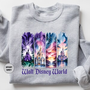 A gray sweatshirt with a graphic design featuring four colorful castle scenes and fireworks.