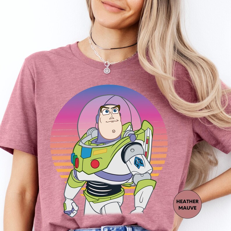 a woman wearing a pink shirt with a cartoon character on it