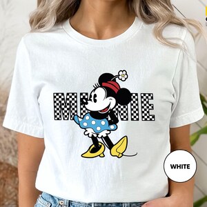 a woman wearing a mickey mouse t - shirt