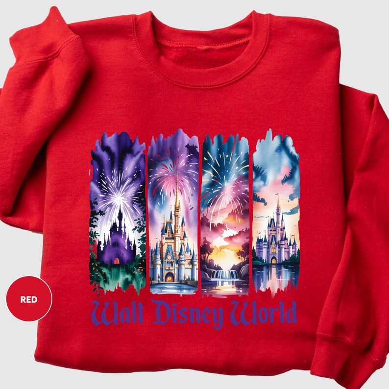 A red sweatshirt with a graphic design featuring four different castle scenes and fireworks.