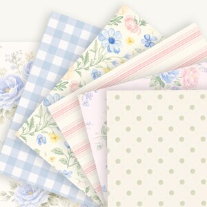 Puede incluir: Una colecci&oacute;n de papeles estampados en abanico. Los dise&ntilde;os incluyen cuadros vichy azul claro, estampados florales con flores azules y rosas, rayas rosas y un patr&oacute;n de lunares crema.