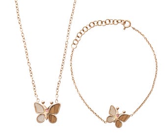 May include: A gold-toned necklace and bracelet set. Each piece features a butterfly pendant with light and dark brown wings, a white center, and a small pink gem. The jewelry is displayed on a white background.