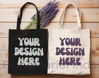 May include: Two tote bags, one black and one white, with the text "YOUR DESIGN HERE" in a retro font. The black bag has white text and the white bag has purple text. The bags are on a wooden surface with a bunch of lavender flowers.