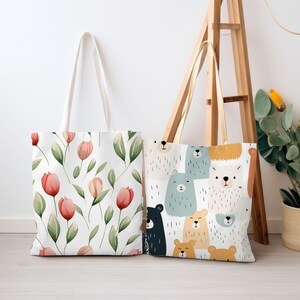 May include: Two tote bags with different designs. One bag features a floral pattern with pink tulips and green leaves on a white background. The other bag has a pattern of cartoon bears in various colours and expressions on a white background.