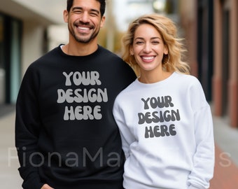 May include: Two people wearing black and white sweatshirts with the text "Your Design Here" in a retro font.