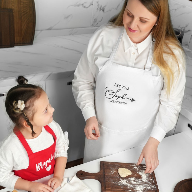 a woman and a little girl in a kitchen