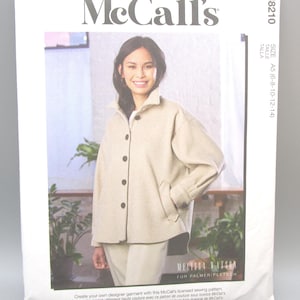 May include: A McCall's sewing pattern packet featuring a woman wearing a beige jacket and pants. The packet includes the McCall's logo, pattern number M8210, and size information. The packet also includes the text "MELISSA WATSON FOR PALMER/PLETSCH".
