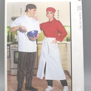 May include: McCall's sewing pattern featuring chef attire. The pattern includes a chef's jacket, pants, apron, and hat. The image shows a man and woman wearing the chef's uniform. The pattern is size A (S-M-L-XL-XXL).