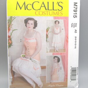 May include: A McCall's Costumes sewing pattern, M7915, featuring a woman in a peach and white corset and skirt. The pattern includes multiple views of the costume, with the text "Angela Clayton" at the bottom. Size A5 (6-8-10-12-14).