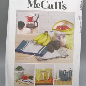 May include: McCall's sewing pattern featuring various reusable produce bags, a cooler bag, and a striped tote bag. The pattern also includes instructions for making a coffee maker and other kitchen accessories. Designed and printed in the USA.