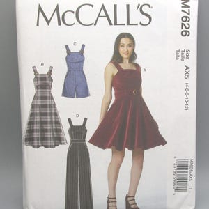 May include: A McCall's sewing pattern envelope featuring illustrations of various dress and jumpsuit designs. The envelope includes the pattern number M7626 and size AX5 (4-6-8-10-12). The main image shows a woman wearing a burgundy dress.