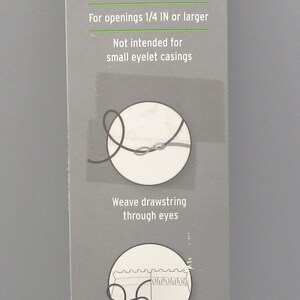 May include: A drawstring threader by Fabany, with a light blue handle and a gray card. The card features instructions and text, including "Replace or add drawstrings" and "23 IN (58 cm)".