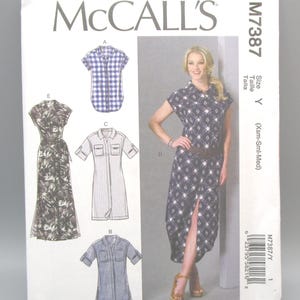 May include: McCall's M7387 sewing pattern. The pattern features illustrations of various shirt dresses, including a blue and white plaid short-sleeve shirt, a striped dress, and a blue denim shirt. The size is Y (Xsm-Sml-Med).