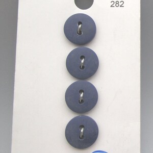May include: Four navy blue, round buttons with metal shanks are displayed on a white card. The card has the number 282 printed at the top and the logo "JHB" at the bottom. The buttons are evenly spaced.
