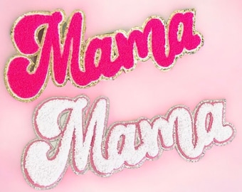 May include: Two felt patches with the word "Mama" in a retro font. The top patch is pink with gold glitter trim. The bottom patch is white with silver glitter trim.