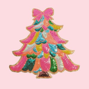 May include: A vibrant sequined Christmas tree decoration. The tree has a pink bow and is decorated with sequins in pink, yellow, teal, orange, and green. The edges are outlined with gold glitter.
