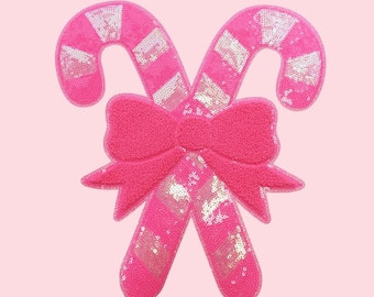 Toppa natalizia con bastoncino di zucchero con paillettes rosa, fiocco in ciniglia, stirabile