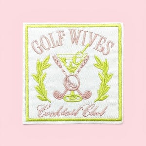 May include: A square embroidered patch with a white background and a lime green border. It features the text GOLF WIVES in pink, a martini glass, two crossed golf clubs, and two leafy branches in lime green, with the text Cocktail Club in pink.