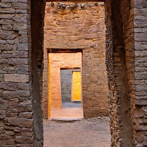 May include: A view through a series of doorways in a stone building. The doorways are lined up in a row, with each one leading to the next. The light coming through the doorways creates a warm, inviting glow.
