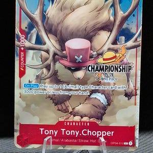 May include: A One Piece Championship card featuring Tony Tony. Chopper. The card has a red border with the number 3 and the text "COUNTER +1000". The illustration shows Chopper with large antlers and a pink hat. The card also has the text "CHAMPIONSHIP" and "ONE PIECE".