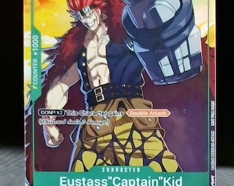 Puede incluir: Una carta de intercambio con Eustass "Captain" Kid del anime One Piece. La carta es verde, amarilla y roja con una imagen de Kid en el centro. La carta tiene un nivel de poder de 4000 y un contador de +1000. El texto de la carta dice "DON!! x2 Este personaje gana Ataque Doble (Esta carta inflige 2 daños)".