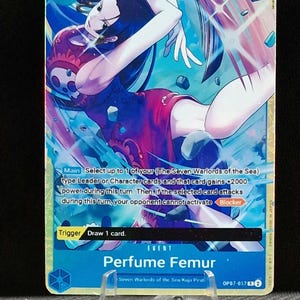 May include: A trading card with a character in a red dress and long black hair, set against a blue and purple background. The card has the number 2 in the top left corner and text that reads "Perfume Femur".