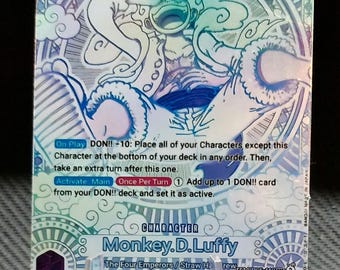 May include: A blue and white holographic trading card featuring Monkey D. Luffy from the One Piece anime series. The card has a power level of 12,000 and a DON!! ability that allows the player to place all of their characters except this one at the bottom of their deck in any order and take an extra turn. The card also has an activate ability that allows the player to add up to 1 DON!! card from their DON!! deck and set it as active.