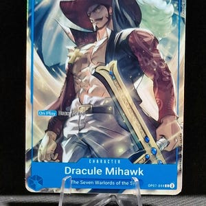 May include: A trading card featuring Dracule Mihawk from "The Seven Warlords of the Sea." The card has a blue background with the number "8" in the upper left corner and "10000" in the upper right. The character is depicted with a large hat and a sword.