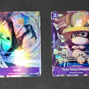 May include: Six collectible trading cards featuring characters from an animated series. The cards have vibrant, holographic designs with character names and numbers. The cards are primarily purple, with accents of blue, pink, and green.