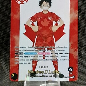 May include: A collectible trading card featuring Monkey D. Luffy wearing a red Canada soccer jersey with a maple leaf pattern, balancing a soccer ball on his head. The card displays the Canada Soccer logo, 5000 power, and game text instructions.