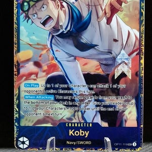 以下が含まれることがあります： アニメシリーズOne Pieceのキャラクター、コビーをフィーチャーしたトレーディングカード。カードは青色の背景に、アクション中のコビーのダイナミックなイラストが描かれています。カードには数字の8、パワーレベル9000、テキスト「Strike」が表示されています。