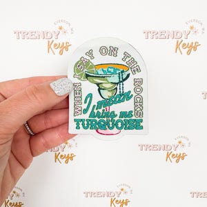 May include: A white sticker with a turquoise margarita glass and the text "When I say on the rocks I mean bring me turquoise".