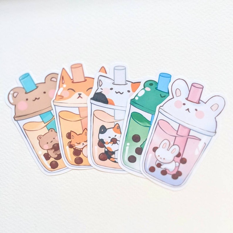May include: Five colorful bubble tea stickers featuring different animal characters. Each sticker has a clear plastic cup with a straw and boba pearls. The animals include a bear, a cat, a frog, and a bunny.