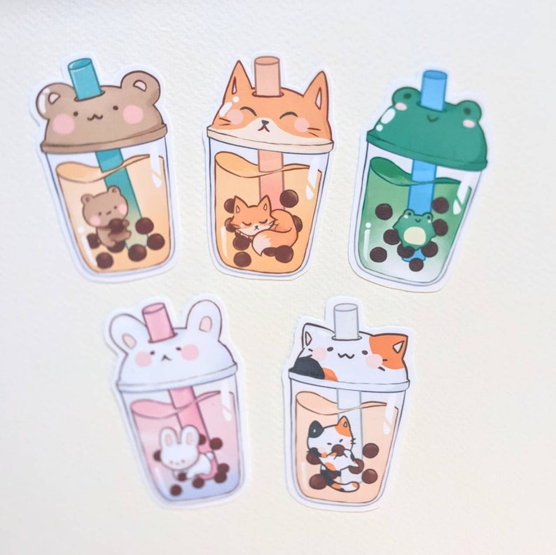May include: Five colorful bubble tea stickers with different animal characters. Each sticker features a clear bubble tea cup with tapioca pearls and a straw. The animal characters are a bear, a fox, a frog, a rabbit, and a cat.