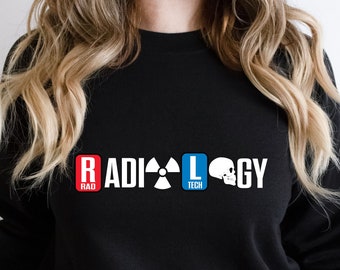 May include: Black sweatshirt with the text "RADIOLOGY" in white letters. The word "RAD" is in a red box, "TECH" is in a blue box, and the word "LOGY" is in white letters. A radiation symbol and a skull and crossbones are between the words.