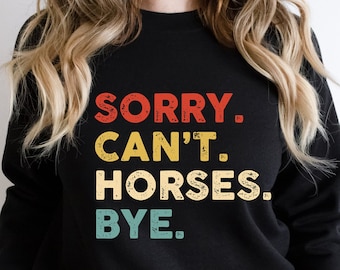 May include: Black sweatshirt with a vintage-style graphic that reads "SORRY. CAN'T. HORSES. BYE."