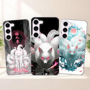 Pode incluir: Três capas de telefone com desenhos de raposas brancas de nove caudas. As capas apresentam a raposa com olhos vermelhos em fundos pretos e brancos. Uma capa tem texto japonês e flores de cerejeira rosa. As capas são para um telefone Samsung.