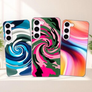 May include: Three phone cases with different abstract designs. The first case has a blue and white swirl pattern. The second case has a pink, green, and black camouflage pattern. The third case has a colorful, abstract, wavy pattern.