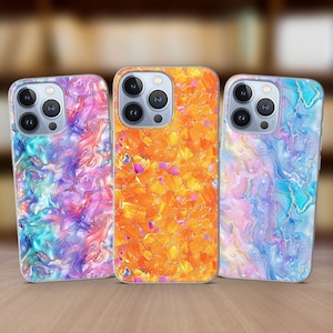 May include: Three iPhone cases with different marble-like designs. The first case has a blue, pink, and purple swirl design. The second case has a yellow and orange swirl design. The third case has a blue, pink, and white swirl design.