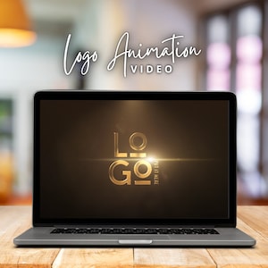 以下が含まれることがあります： 暗い背景に金色のロゴアニメーションが表示されているラップトップコンピューター。ロゴの上に「ロゴアニメーションビデオ」というテキストが表示されています。