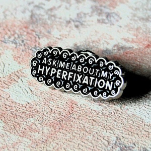 Ask me about my HYPERFIXATION . OCD, obsessive interests, Anxiety, overthinking, mental health awareness. Custom brooches, lapel badges.