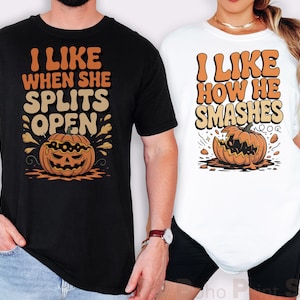 May include: Black and white t-shirts with Halloween-themed graphics. The black shirt says "I LIKE WHEN SHE SPLITS OPEN" with a pumpkin graphic. The white shirt says "I LIKE HOW HE SMASHES" with a broken pumpkin graphic.