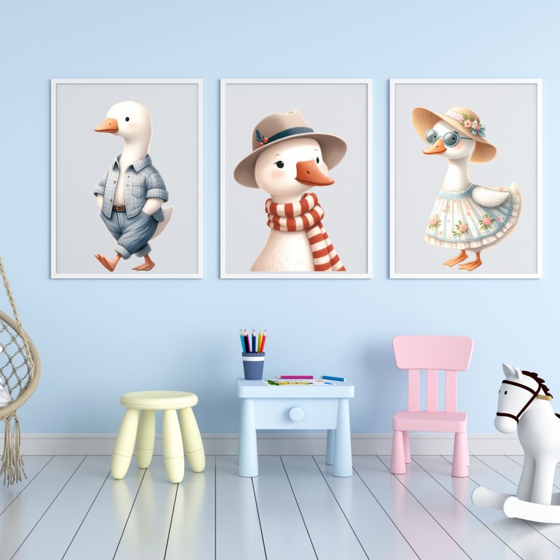 May include: Three framed illustrations of cartoon geese. The first goose is wearing a blue and white checked shirt and blue jeans. The second goose is wearing a red and white striped scarf and a brown hat. The third goose is wearing a white dress with pink flowers and a white sunhat with a pink ribbon.