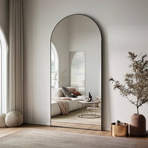 arch-top floor mirror, full-length mirror, leaning mirror, modern minimalist, bedroom statement piece, hallway decor, large mirror, contemporary style, chic interior, spacious design, stylish full view, natural light enhancer, entryway elegance
