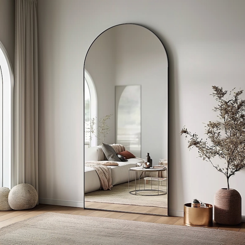 arch-top floor mirror, full-length mirror, leaning mirror, modern minimalist, bedroom statement piece, hallway decor, large mirror, contemporary style, chic interior, spacious design, stylish full view, natural light enhancer, entryway elegance