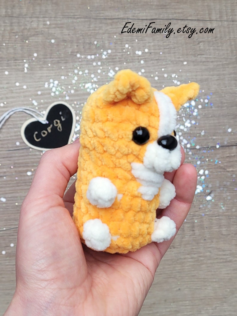 This handcrafted corgi keychain boasts a cute design with soft orange fur, white markings, and charming black bead eyes.