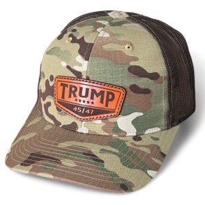 May include: A camouflage trucker hat with a brown leather patch that says "TRUMP 45|47" with five stars.