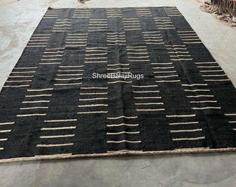 May include: Black and white striped rug with a subtle geometric pattern. The rug is made of natural fibers and has a rustic, handwoven look.