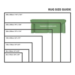 May include: A rug size guide with a standard 3-seater sofa illustration. The guide shows different rug sizes in inches and centimeters, ranging from 24" x 43" to 118" x 157".